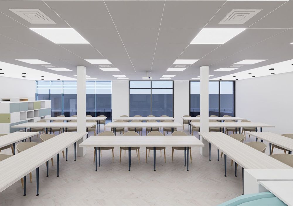 Render of a bright training room with rows of tables and large windows